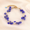 Bracelet yeux tunisiens protecteurs en verre et chaînes métal 0223153 bleu foncé